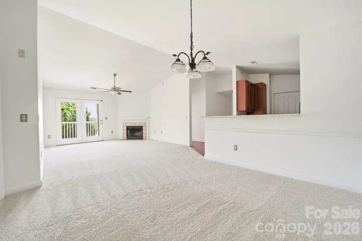 Welcome to 9976 Hyde Glen Court! Vaulted ceiling with a fireplace