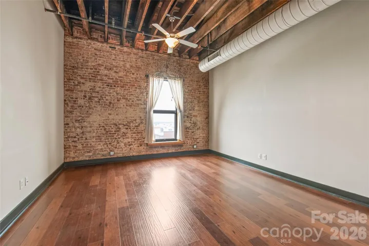 Living Room with amazing exposed brick and beams  gives an urban feel