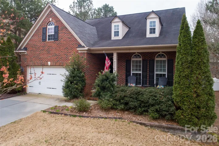 Front of home, partial brick with front porch for sitting
