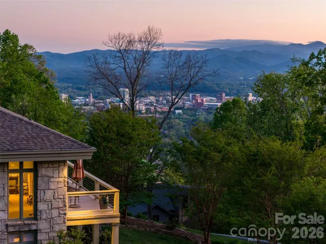 Sunset settles softly as Asheville begins to glow below.