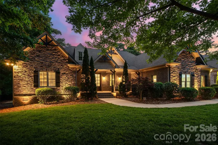 Full brick with stone accents French Country inspired home.
