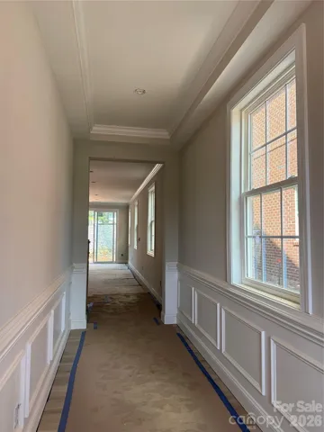 Foyer with tray ceiling, crown molding, chair rail and wainscoting