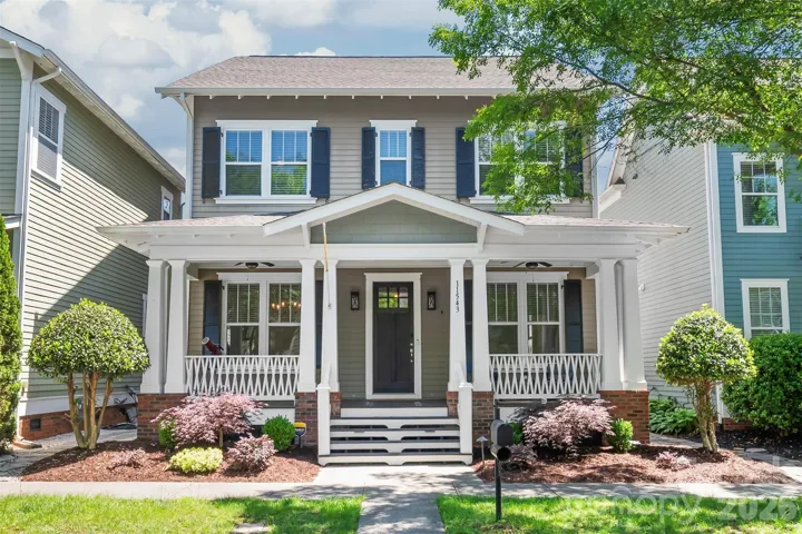 Step into a world of timeless elegance with this stunning Charleston-style exterior, where a wide, inviting covered front porch serves as the perfect spot for morning coffee.