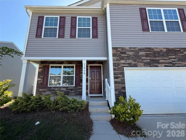 nice covered front porch and stone accents on the house with corner lot and cul de sac street, less traffic for the kids to play