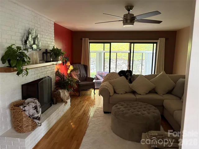 Living room view toward sunroom with 9' glass door separation into Sunroom/office
