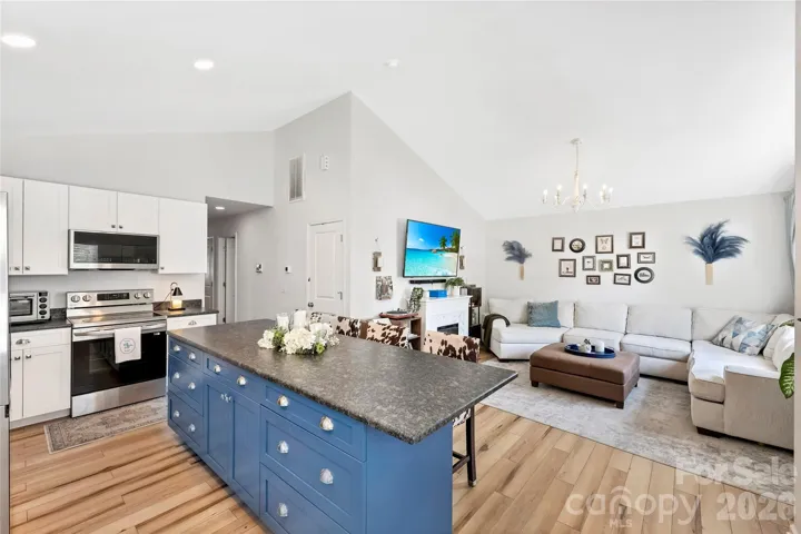 Bright open-concept living space with vaulted ceilings and seamless flow throughout the main living areas.