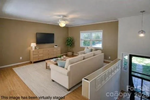 Open floor plan is ideal for entertaining!  Spacious family room with ceiling fan.