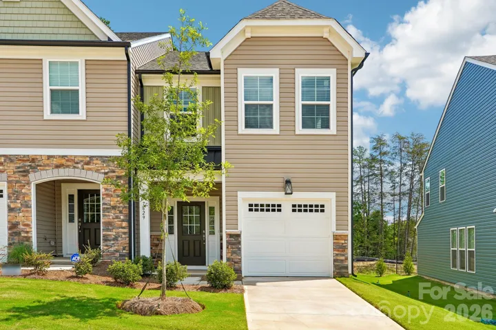 Inviting townhome exterior with an attached garage and charming curb appeal.