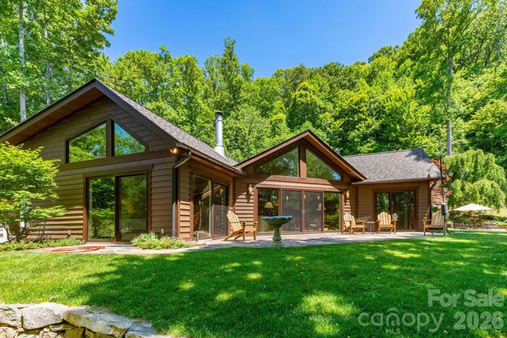 Main House. Nestled within beautifully landscaped grounds and mature trees, this exceptional home offers privacy, serenity, and a true connection to the natural beauty of the mountains.