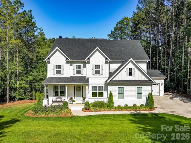 Incredible curb appeal meets timeless style in this stunning home featuring a durable fiber cement exterior, welcoming front porch, 3 car garage, manicured landscaping, and peaceful wooded surroundings.