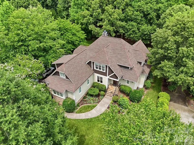 Welcome to 184 Ashmore in Troutman NC! Beautiful aerial perspective showcasing the home's mature landscaping and private wooded surroundings.