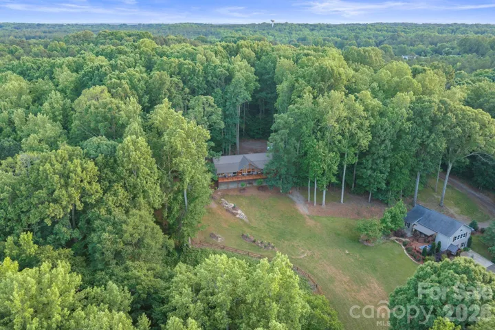 Aerial view of barndominium and cottage