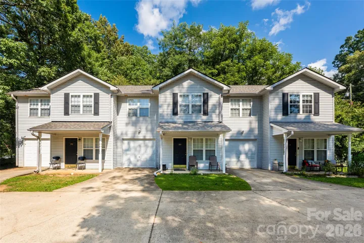 Three Townhome Units - each with private garage. Additional parking to the right of the building.