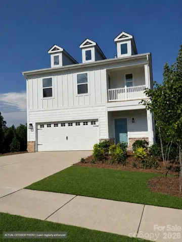 Actual exterior photo. Lawn digitally enhanced.