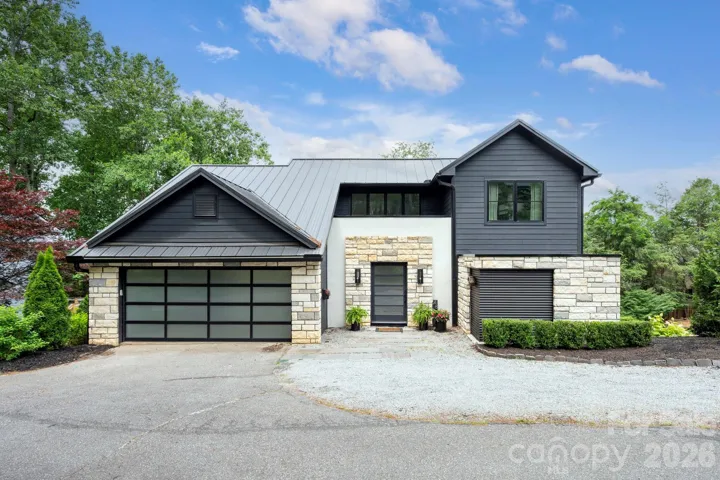Sophisticated, luxurious, and strikingly contemporary, this feature-rich mountain retreat sits on a quiet dead-end street in the heart of walkable North Asheville’s beloved Grace neighborhood.