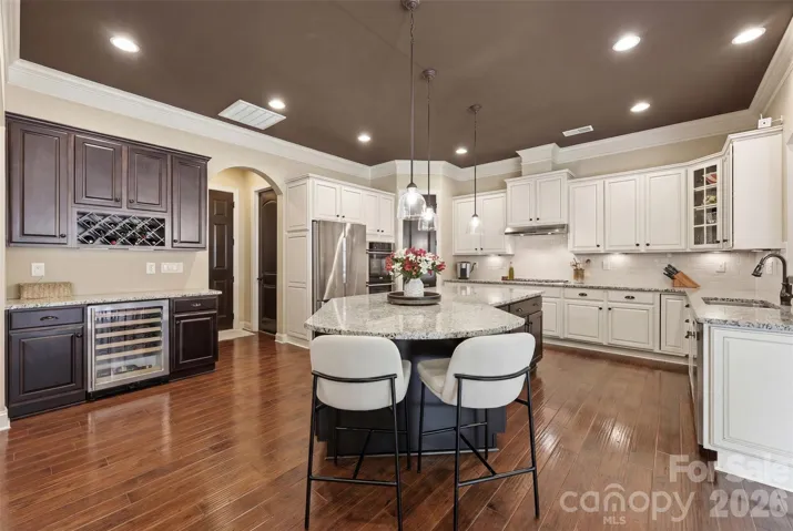 Kitchen, double ovens, large island, thermador cooktop, rollout cabinet drawers, wine fridge