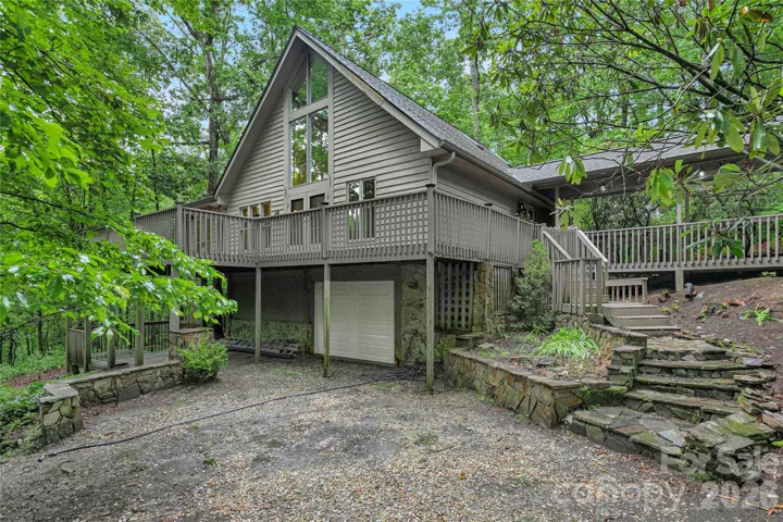 Welcome to 56 Guque Court in Connestee Falls! The house has an attached one-car garage in the basement