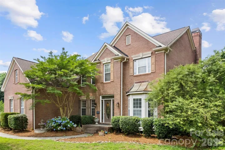 Brick home on corner lot with fenced yard