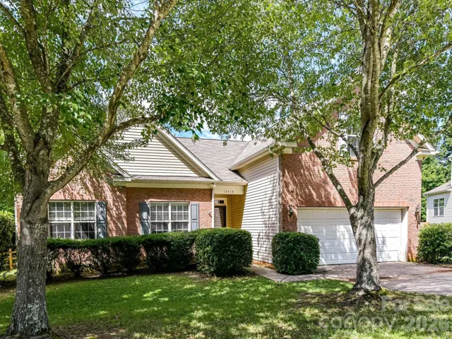 Nestled among mature trees on a spacious corner lot, this beautifully maintained brick home offers timeless curb appeal, a side-entry garage, and a welcoming setting in a sought-after neighborhood.