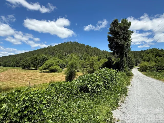 Property is the hill beyond the field.