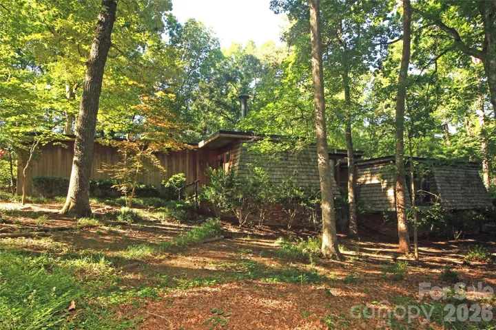 This custom contemporay is ideally situated on a hill top flat that emphasis the privacy and beauty of this wooded lot.  The expansive windows in this home provide every room with beautiful views with lots of natural light.