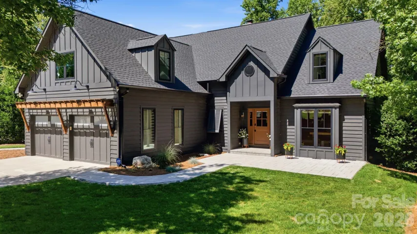 Elegant Lake Norman home with timeless curb appeal, lush landscaping, and an inviting front entry. A strong opening image that immediately establishes the home’s polished, luxury presence.
