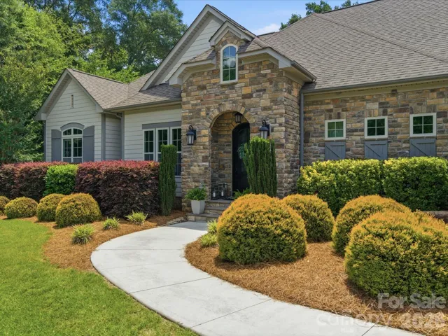 Stone and Hardiplank adorn the entry of this custom designed dream home on 1.07 acre in premier Concord location!