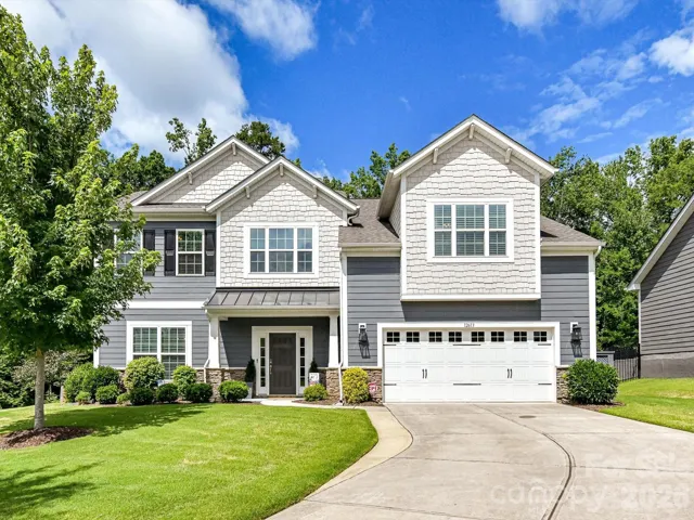 Beautifully crafted home with charming curb appeal, featuring elegant architectural details, a spacious two-car garage, and a professionally landscaped yard in a desirable neighborhood setting.