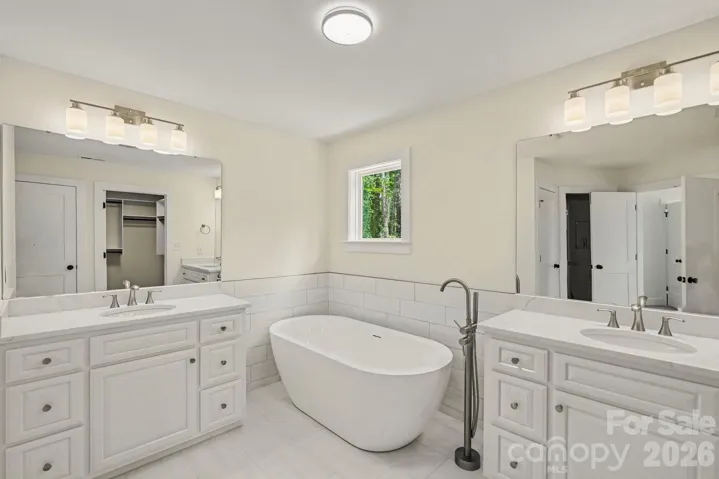 Gorgeous primary bath with dual vanities, vessel tub and huge  walk in tile shower