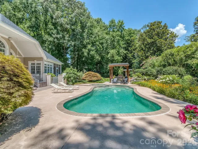 Outdoor oasis with outdoor kitchen and in-ground firepit with built in seating.