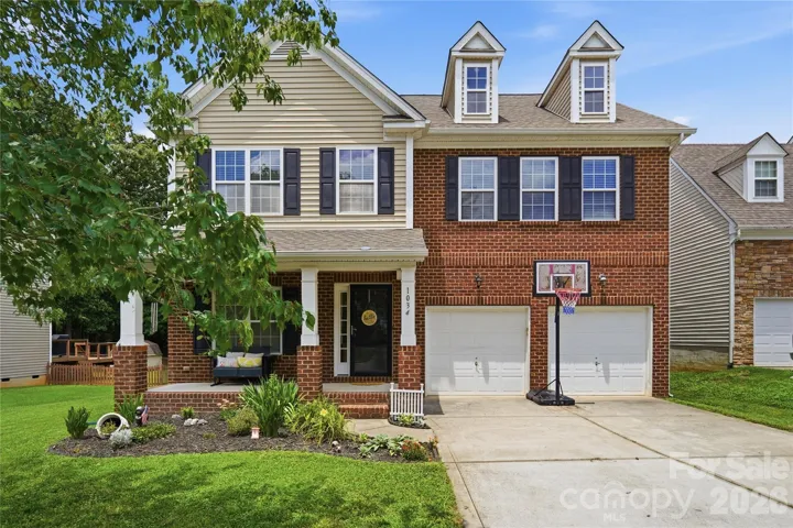 Classic brick-front curb appeal with a welcoming covered porch