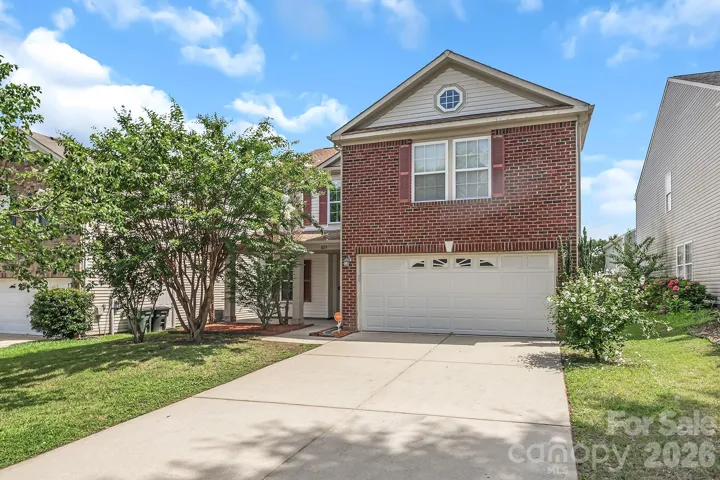 Brick front home with long driveway