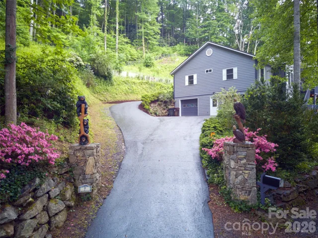 Handsome driveway entry with flanking sculptures