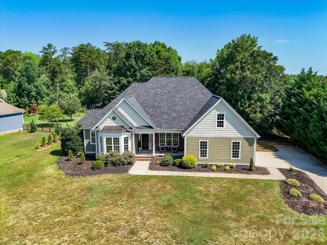Elegant curb appeal welcomes you home with charming architectural details, manicured landscaping, and a covered front porch that creates a warm and inviting first impression.