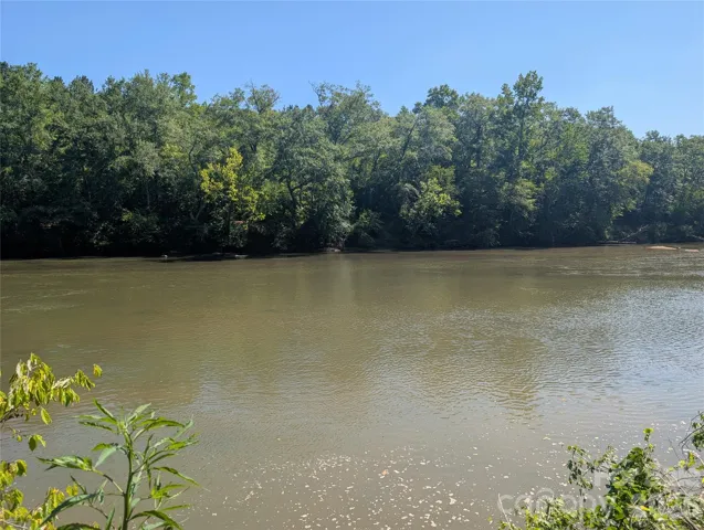 Lot slopes down to the beautiful broad river