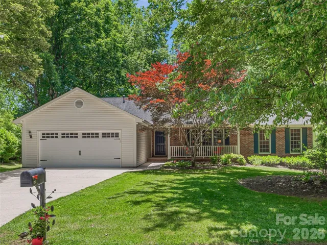 Level yard, concrete driveway and mature Japanese Maple welcome you home
