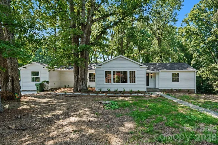 Updated 4BD/3BA ranch set back on a private, tree-lined lot featuring brand-new Hardie Siding, bright picture windows, and a spacious shaded front yard.