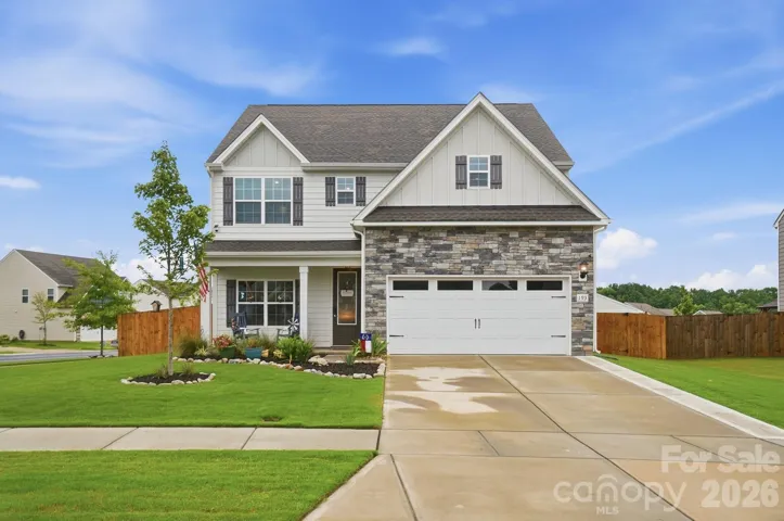 Front of home with widened driveway