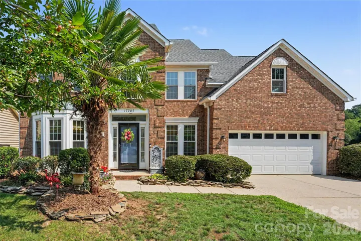 Front with mature landscaping.
