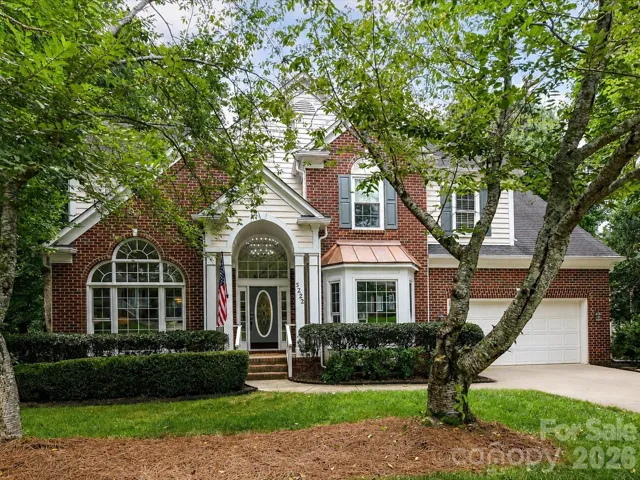 Beautiful curb appeal welcomes you home with a freshly pressure-washed driveway, mature landscaping, and timeless brick architecture that creates an inviting first impression.