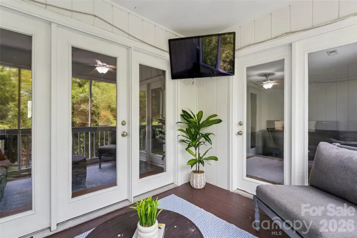 Outdoor space with mounted TV for outdoor entertainment