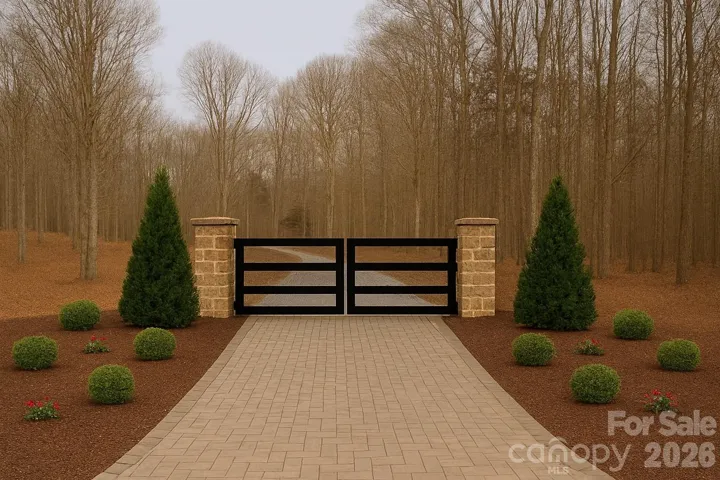 A beautiful stone-paver entrance, framed by custom stone pillars and an elegant aluminum gate, welcomes you home.