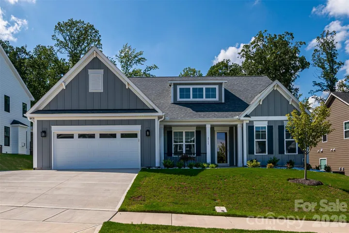 Upgrades of board and batten were added to entire front elevation as well as decorative gable brackets and wrought iron porch railing. The owners also added the parking pad to the driveway. The seller also extended a portion of the garage 2 foot wide by 15 foot deep. Also added additional insulation to garage walls and ceiling. There's even a dedicated freezer curcuit in the garage.