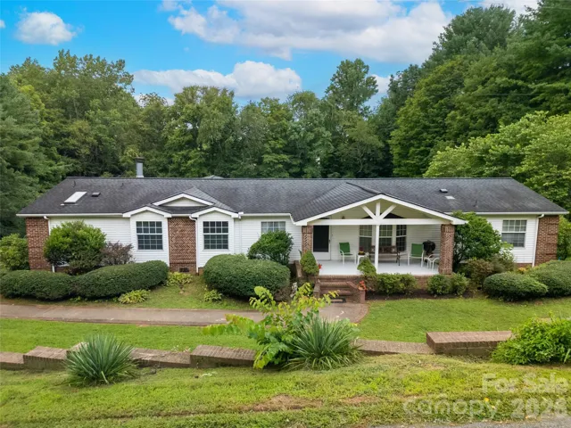 Front of the house with pleasant patio porch to sit and enjoy the fireflies and flowers in spring! Beautiful Custom Brick Work all across the front!
