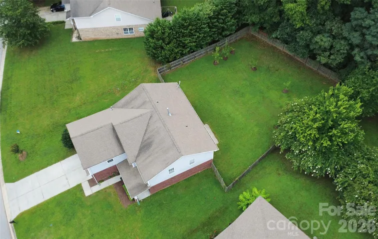 Situated on an oversized lot backing up to a 50-foot permanent wooded buffer with zero direct rear neighbors