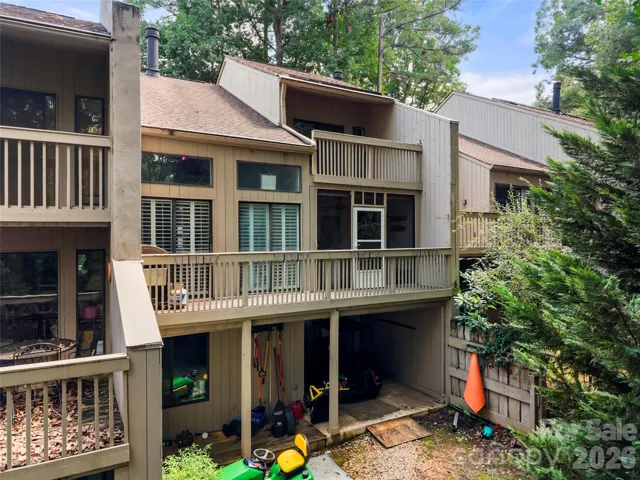 View of back with 3 levels of patio, screened in porch and covered deck