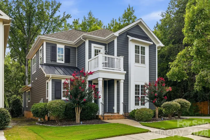 Welcome home to this charming Davidson residence, beautifully framed by lush green lawn and mature landscaping.