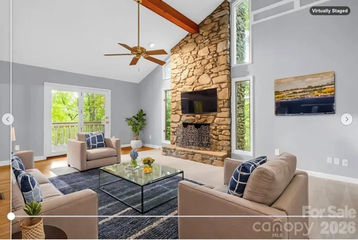 virtually staged: Den with stone fireplace off of Kitchen & Dining Room, door to covered patio & open Deck