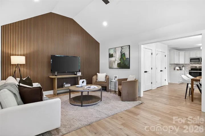 Vaulted ceiling family room with wood accent wall!