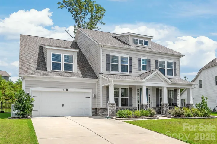 An expanded, long driveway leads to the two-car garage, offering plenty of space for seamless parking and effortless guest arrival.